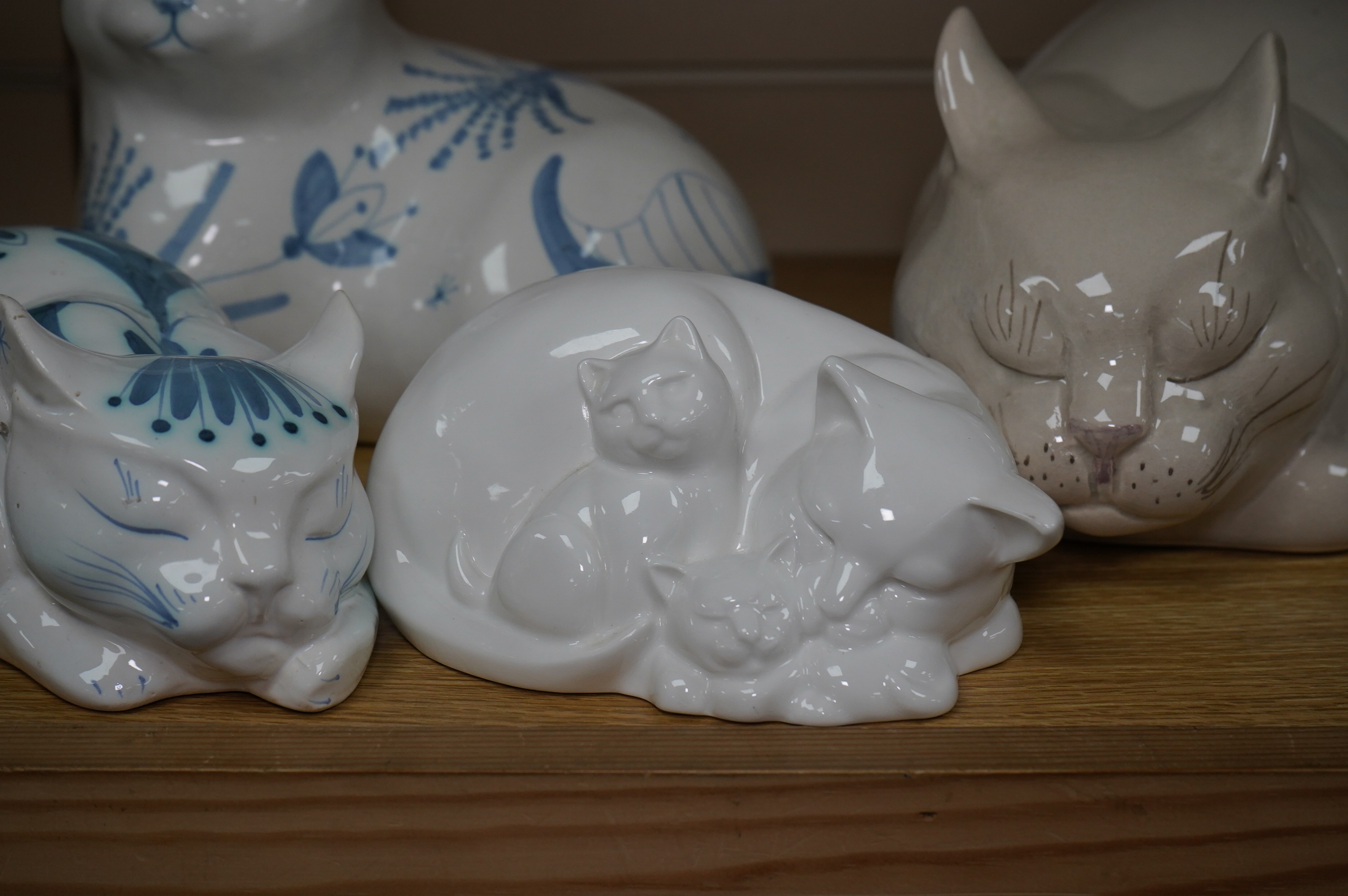 Three large David Sharp Rye pottery models of cats and a Moments by Coalport cat ‘Mothers Love’, tallest 18cm. Condition - largest cat with large firing crack to base otherwise good